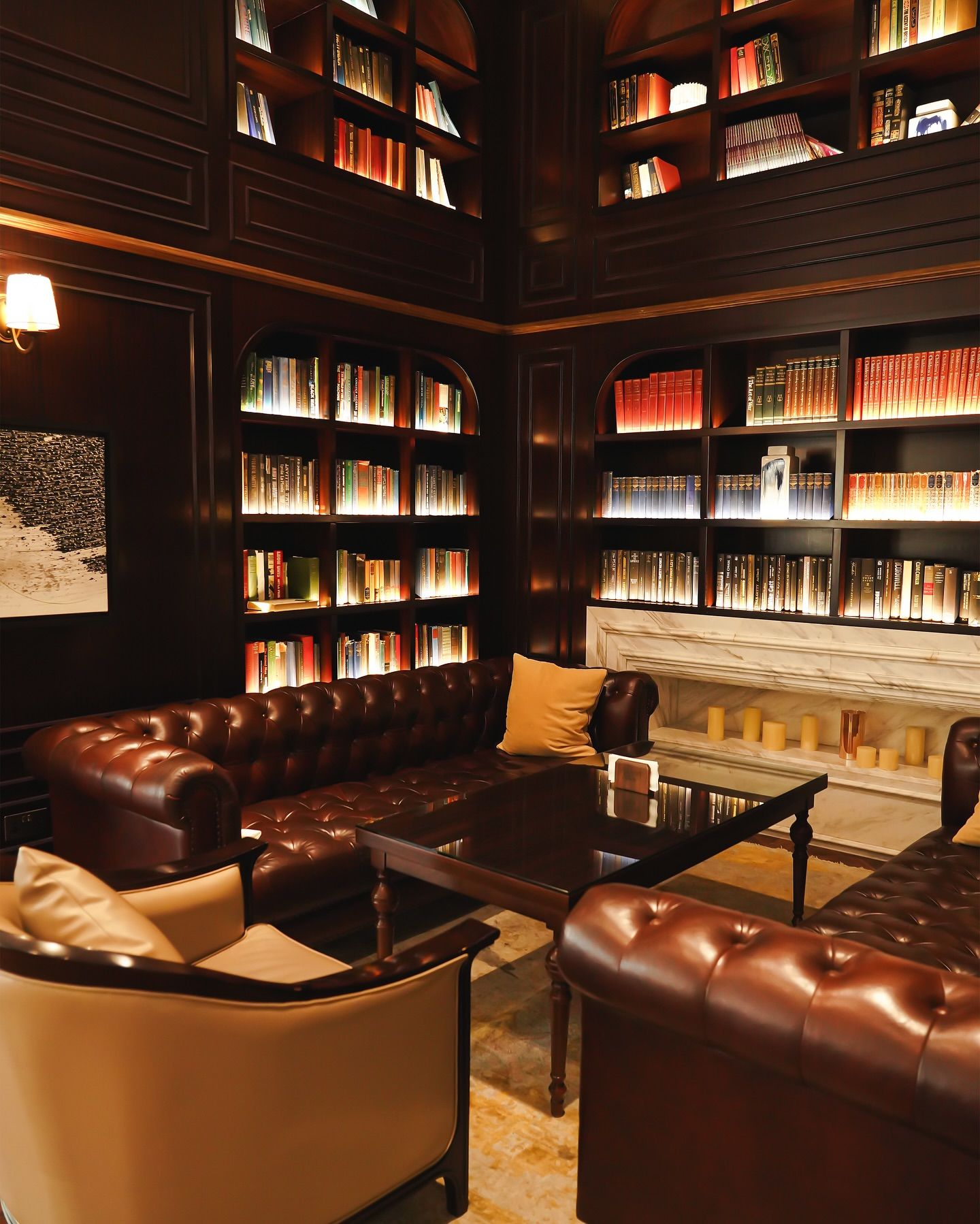 The library lounge, with leather sofas and lit bookshelves